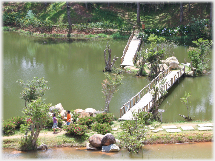 Double bridge to and from rocky islet.