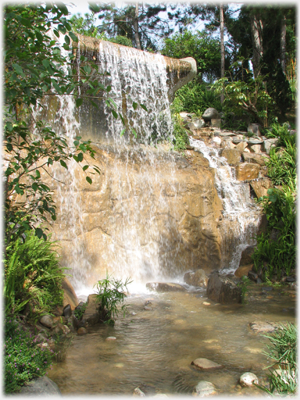 Water pouring over a man made barrage.