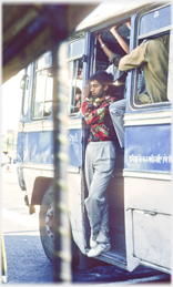 Man at bus door.