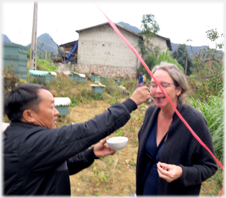 Feeding honey to by-standers.