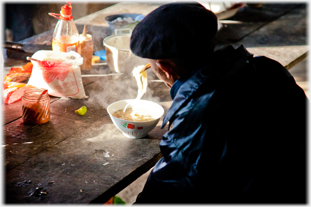 Man eeating pho.