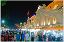 In front of the market at night.