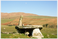 The Cairnholy monument with its stone pointing at a daylight moon.