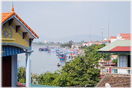 View between houses along the river front.