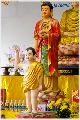 Child and adult figure on alter in the courtyard.