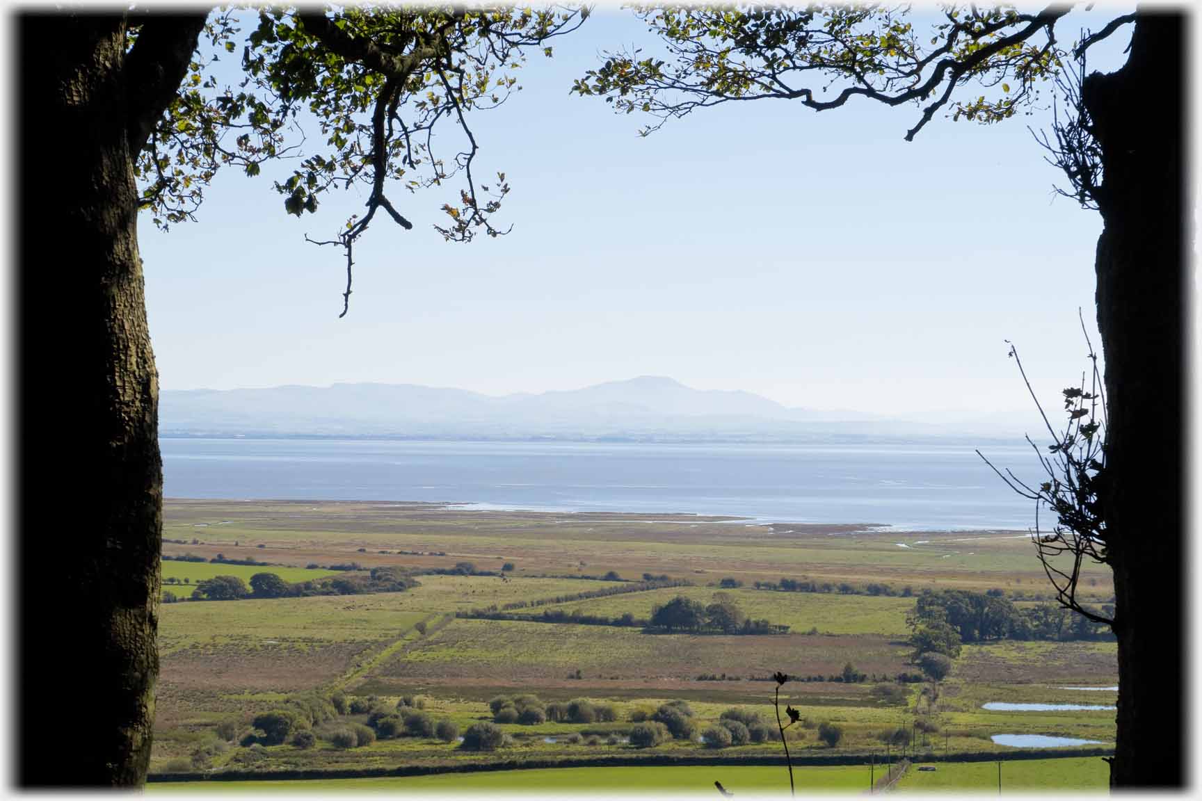 Looking across fields to sea and hills beyond.