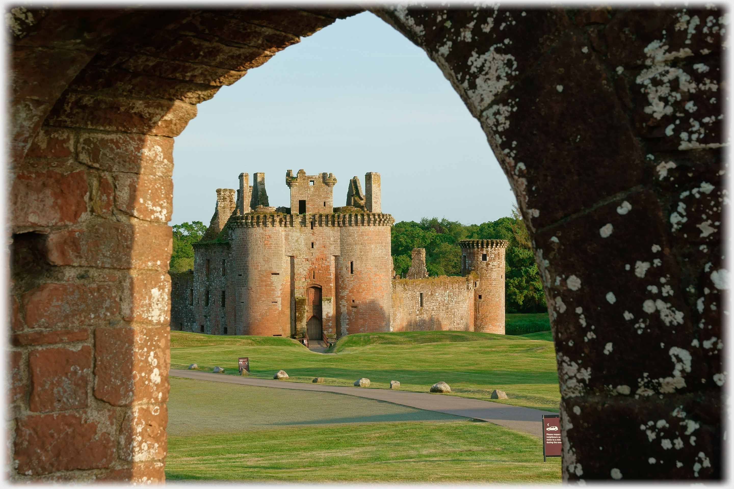 Turreted entrance of apparently triangular castle.