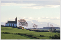 Church on hillside, distant mountain.