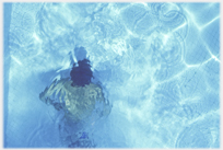 Swimmer under water disguised by reflections.