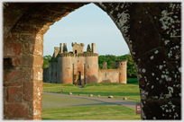 Front of triangular castle seen through arch.