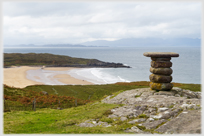 Direction board above sea bay.