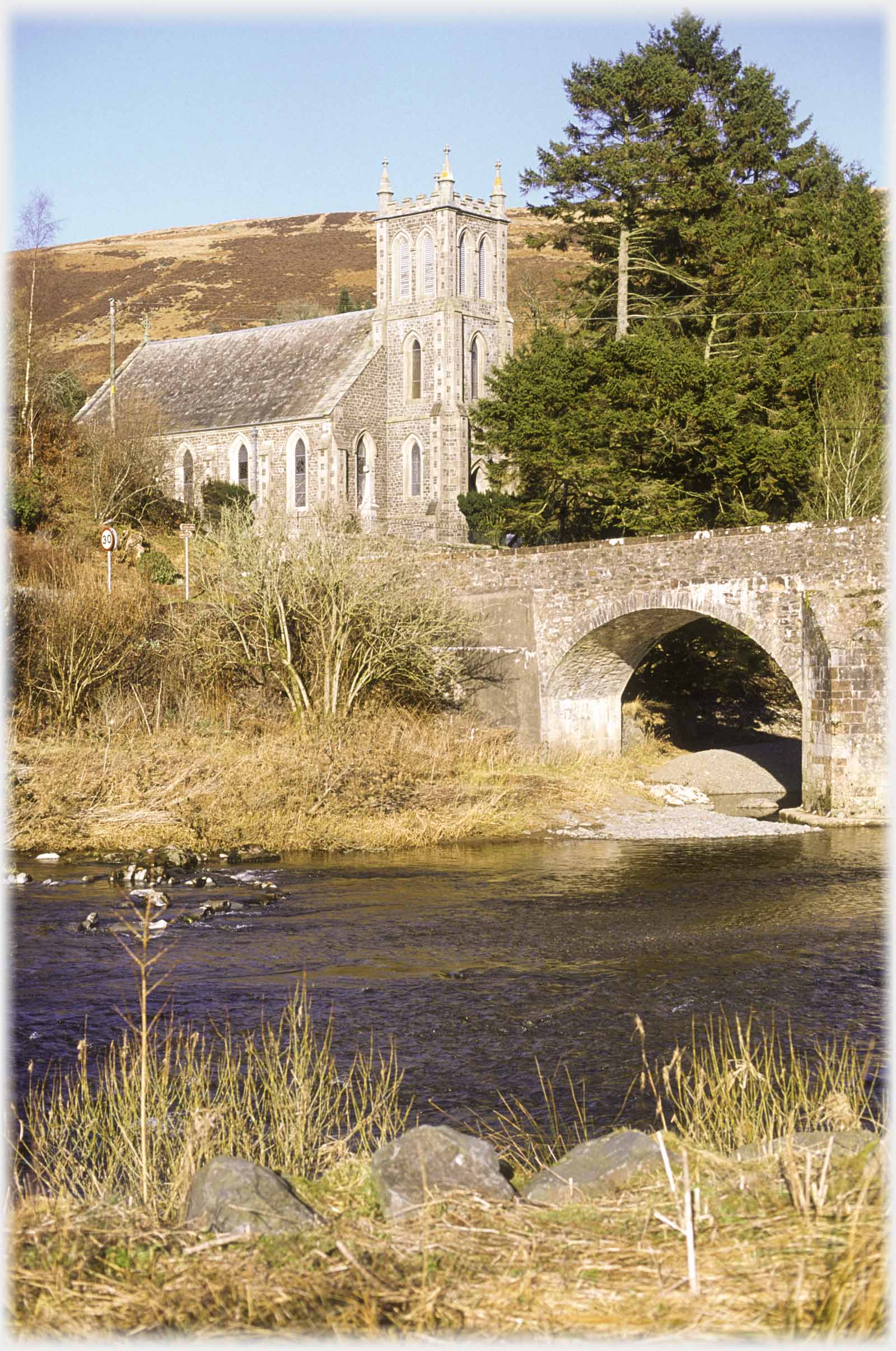 Church next to bridge, river in front.