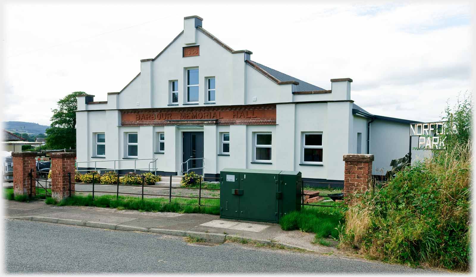 Pitched roof at end of hall with windows on two levels.
