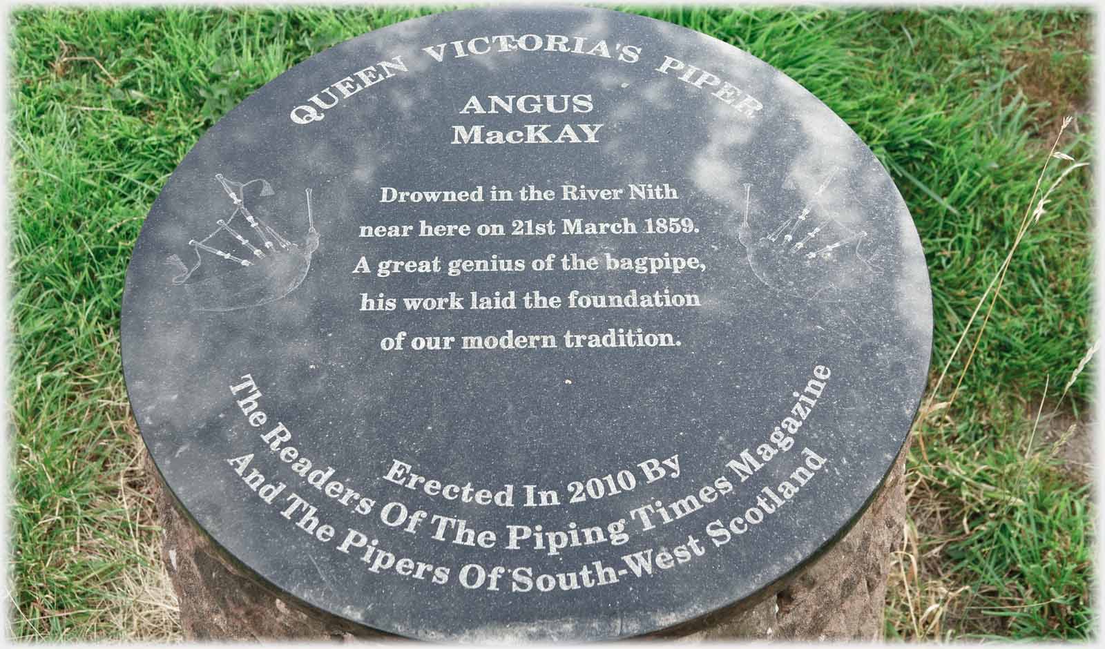 Circular dark slab inscribed in white.