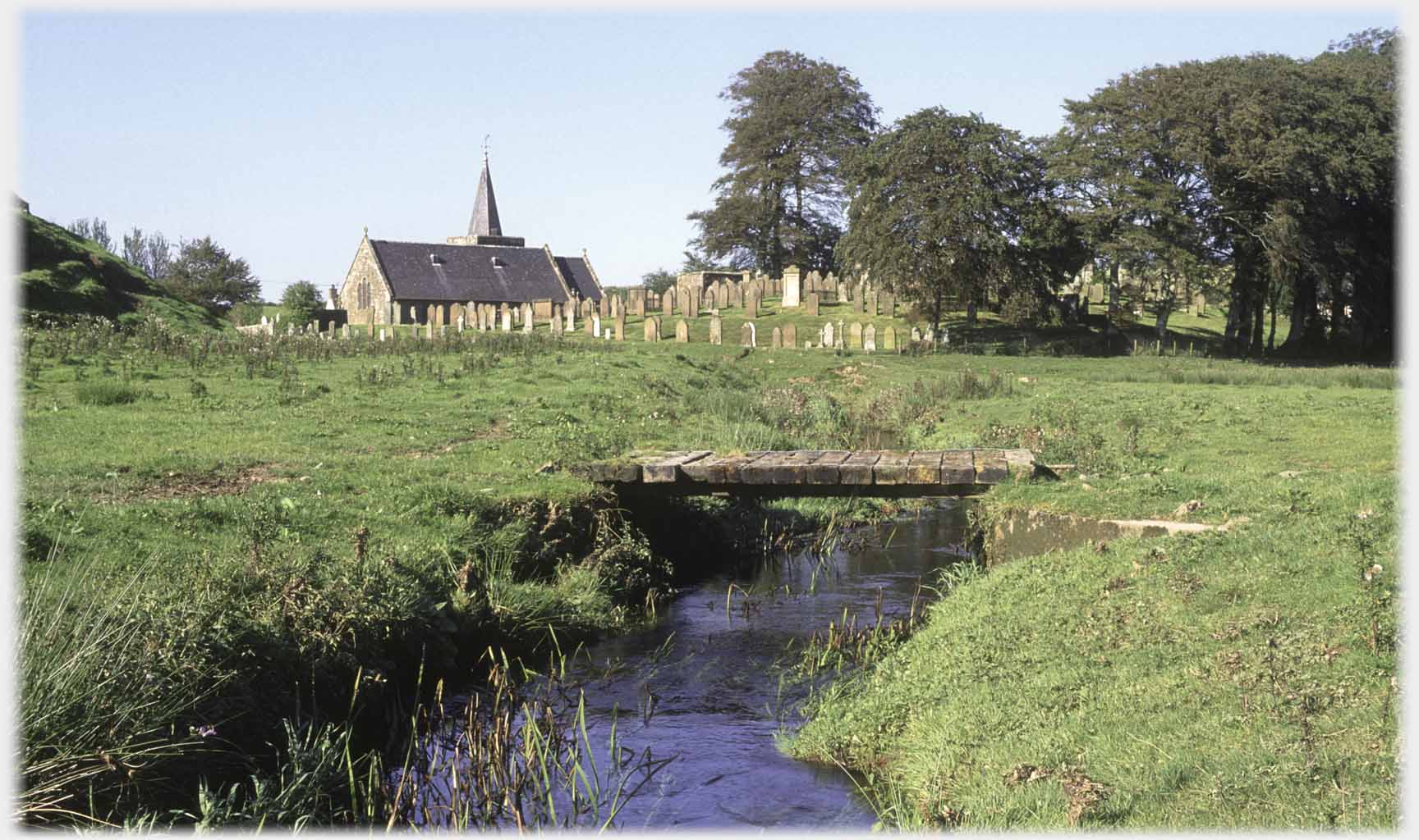 Burn, footbridge, church and graveyard.