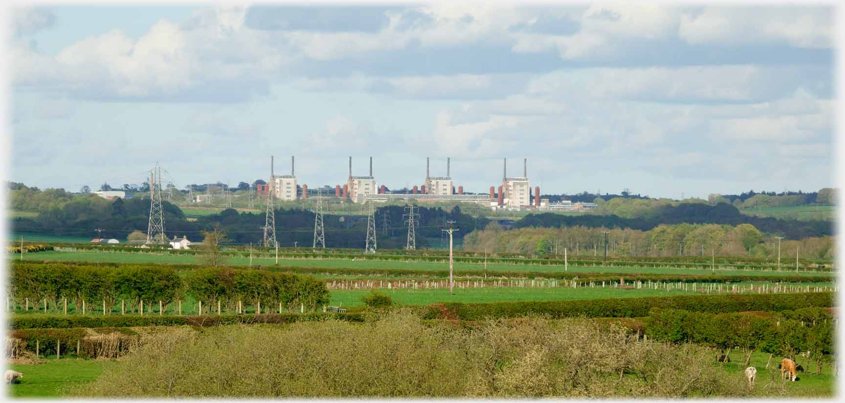Four reactor chimneys in line some miles away.