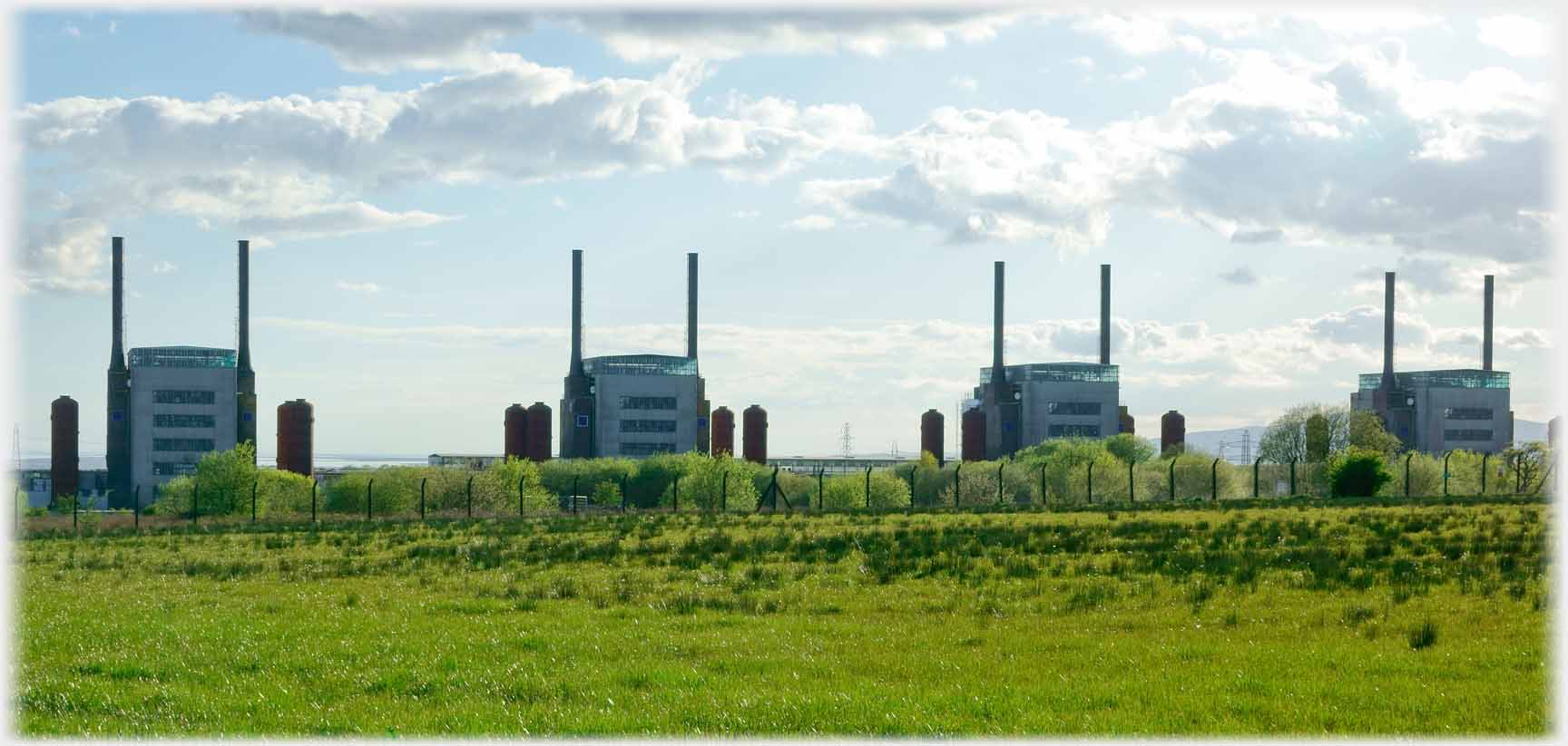Four reactor buildings in line, each with two chimneys.