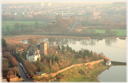 Part of village and kirk with water on on sides.