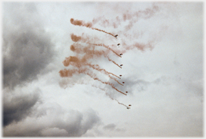 Sky divers parachuting down-wards above calton Hill.