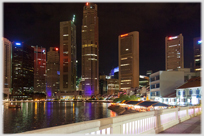 Skyscrapers around Boat Quay at night.