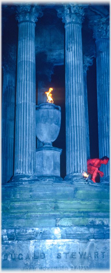 Columns of the Stewart monument with flame appearing to be coming from the urn.