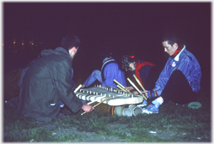 Two players of a wooden xylephone set on piping.