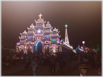 A church with its edges outlined in lights.