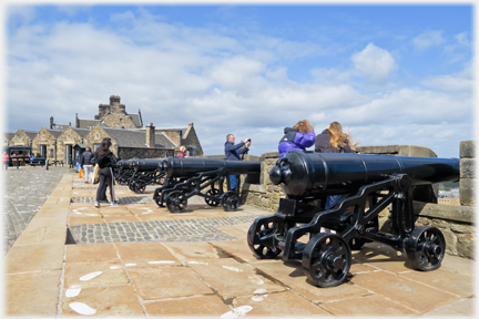 Markings on the ground beside cannons.