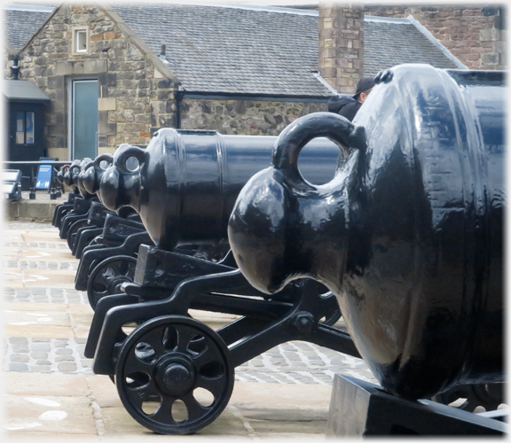 Close view of rear of cannon with others beyond.