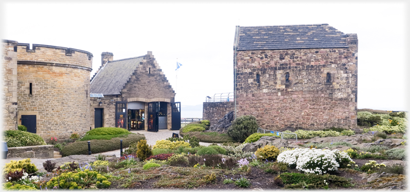 Buildings with extensive rockery in the foreground.