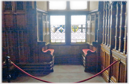 Window with panelling and two bench seats.