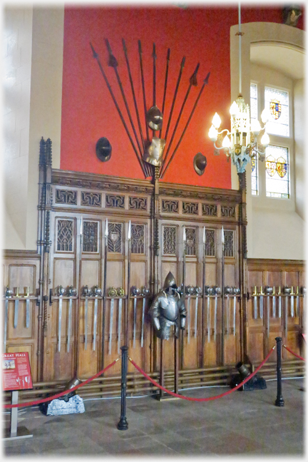 Section of wood panelled wall with display of items attached to it.