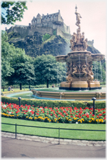 Fountain with statues and castle above.