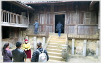 Courtyard with steps up to wooden building.