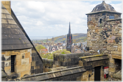 View over wall with churches, hill and seain distance.