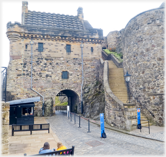 Building above portcullis with flight of steps to its side.