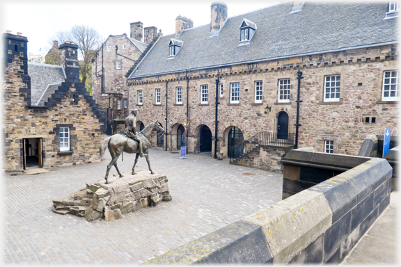 Square with large statue of man on horseback at centre.