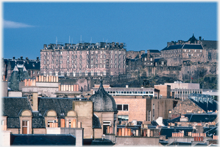 Large block of a building sitting above roof level beside other Castle buildings.