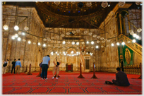 The rich be-lamped interior of the main Citadel Mosque.