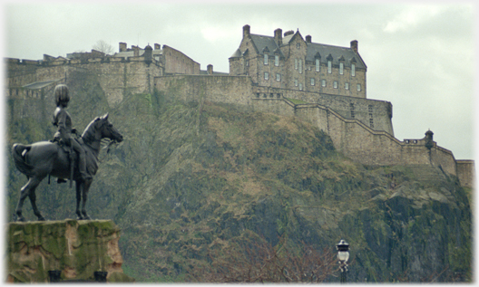Castle from Princes Street with statue of soldier on horseback.