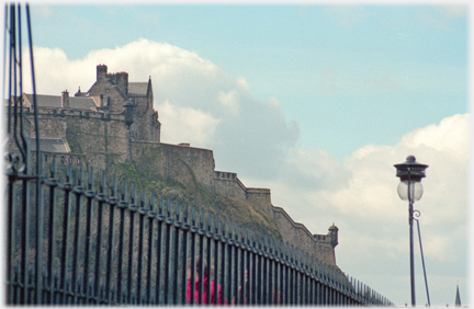 Railings surmounted by castle.