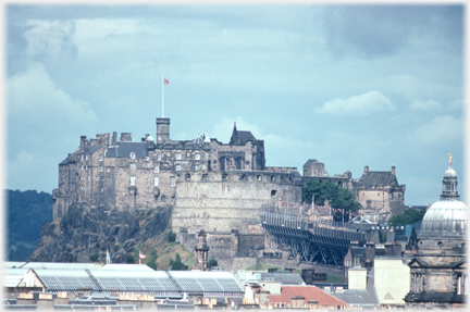 Castle with louring clouds above.