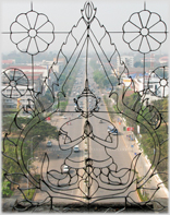 Looking down Vientiane's main thoroughfare through a filigree window.