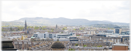 Looking over roofs on south side of town towards hills.