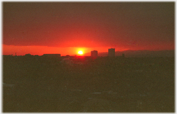 Blood red sun at horizon.