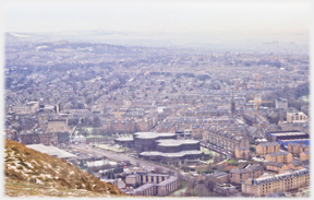 Complex of hexagon roofs with suburb extending around and beyond.