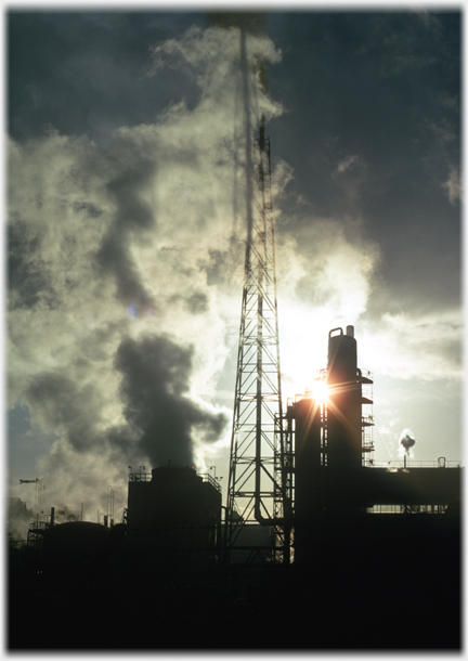 Steam and towers backlit.
