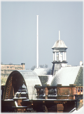 Snow covered roof with flag pole and open turret.