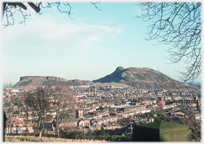 Looking across rooftops to hill.