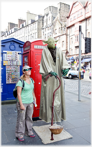 Yoda standing on air next to and above woman.